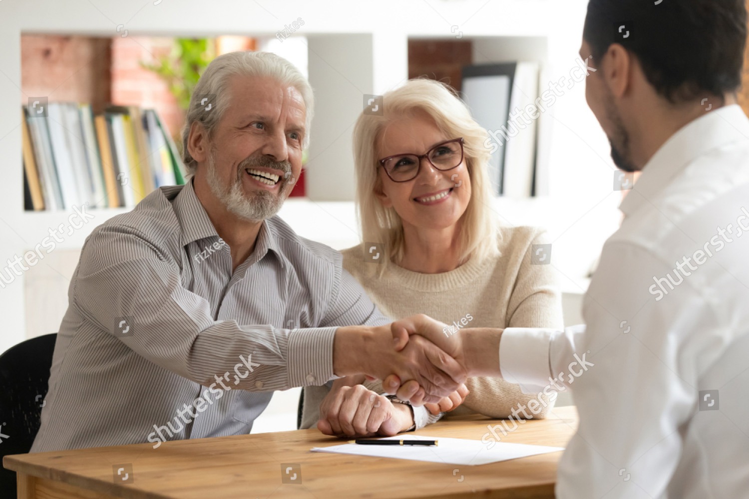 Senior shaking hands with advisor